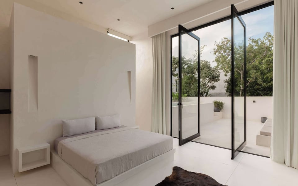 King bedroom with private terrace access and natural light.