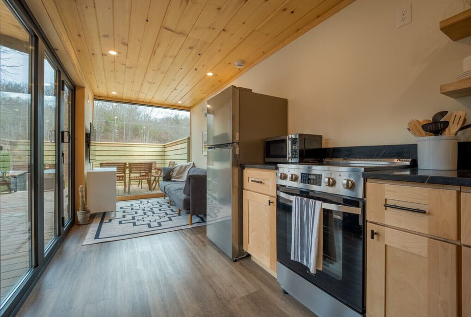 Open-concept living area connecting the kitchen and deck, designed for relaxing after a day outdoors