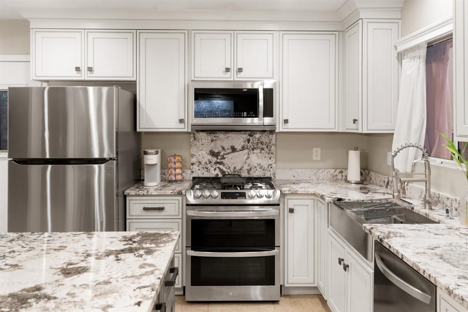 The Kitchen is bright and modern, featuring stainless steel appliances.
