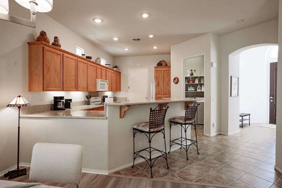 Kitchen counter with counter and bar chairs