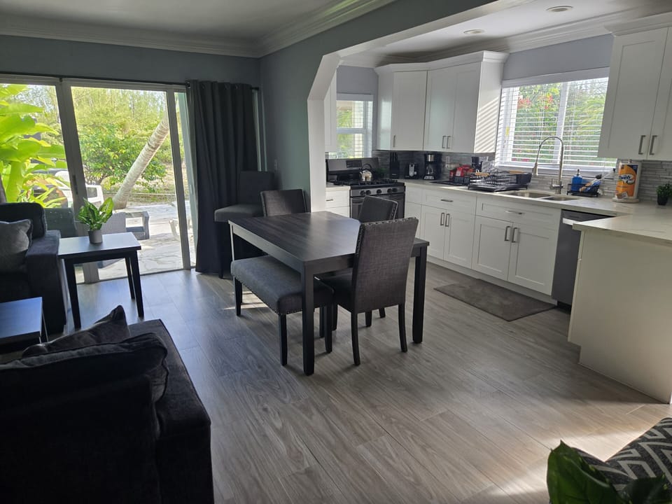 Picture yourself relaxing and conversing with guests in this dining space.