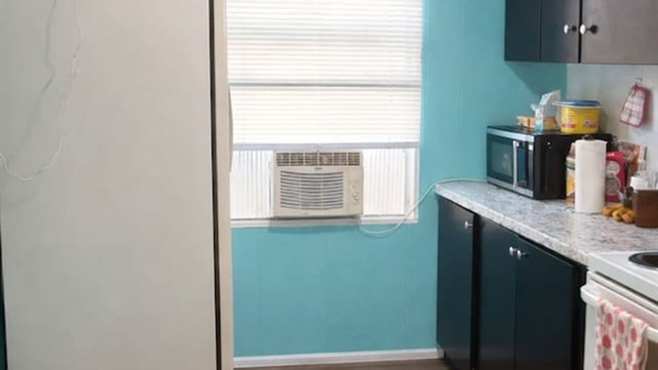 Kitchen area with window AC and appliances