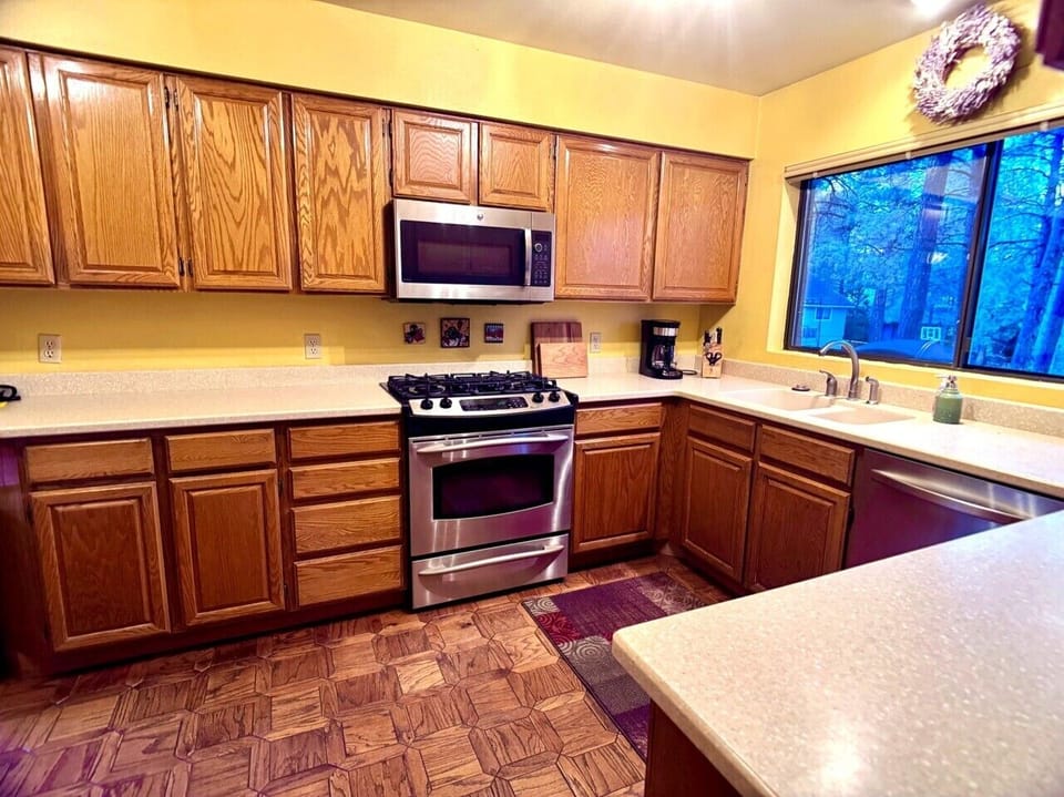 Fully stocked kitchen with gas range, stainless appliances, and plenty of counter space.