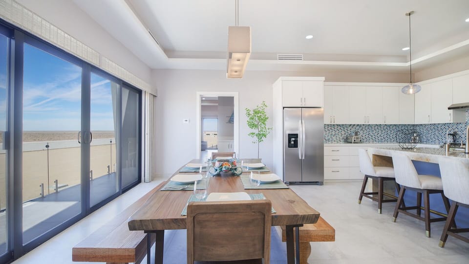 large dining table with sliding door to balcony