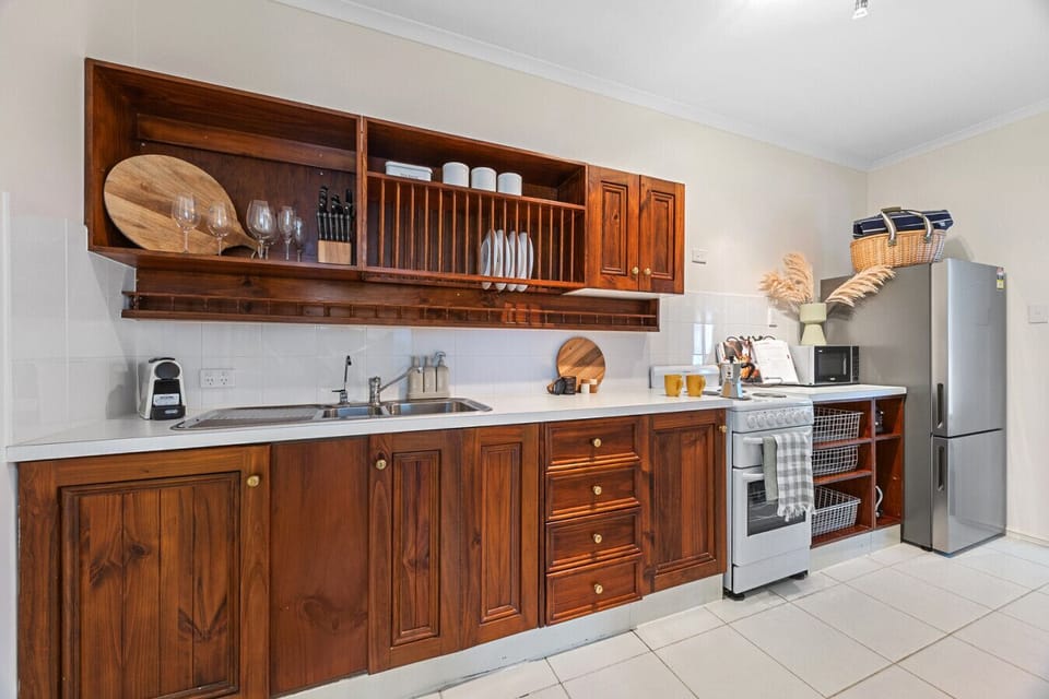 Full kitchenette with cooking utensils, coffee machine and basic pantry items