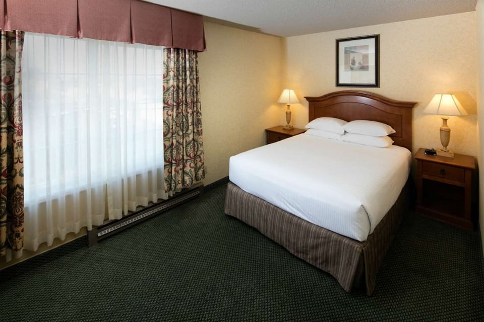 Wake up to soft daylight beside a cozy, inviting bed.