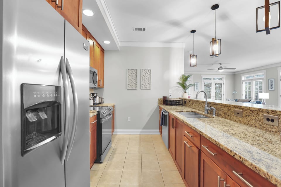 Enjoy morning coffee or evening chats at this sleek kitchen bar with plenty of prep space.