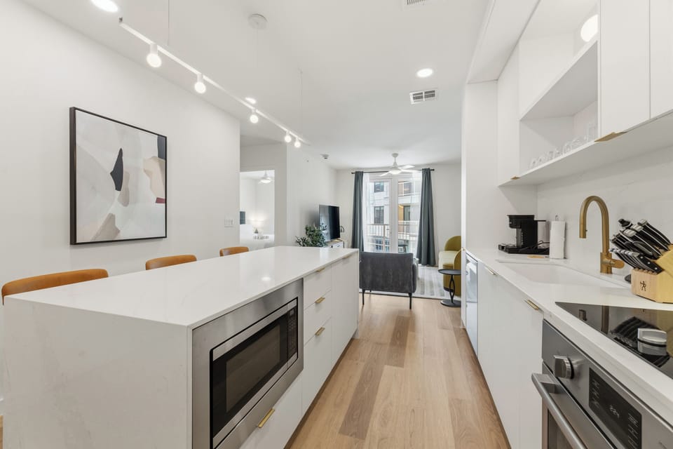 Modern kitchen equipped with stainless steel appliances and ample cabinet space.