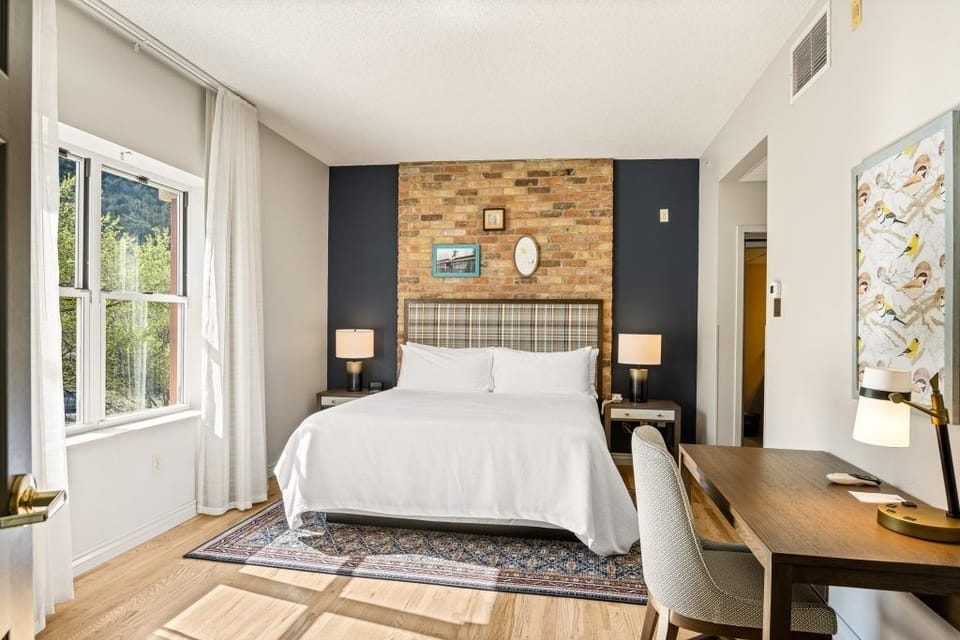 Settle into crisp linens with a dedicated desk for planning.