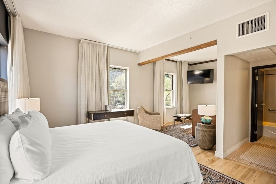 Settle into a spacious suite with cozy seating and TV.