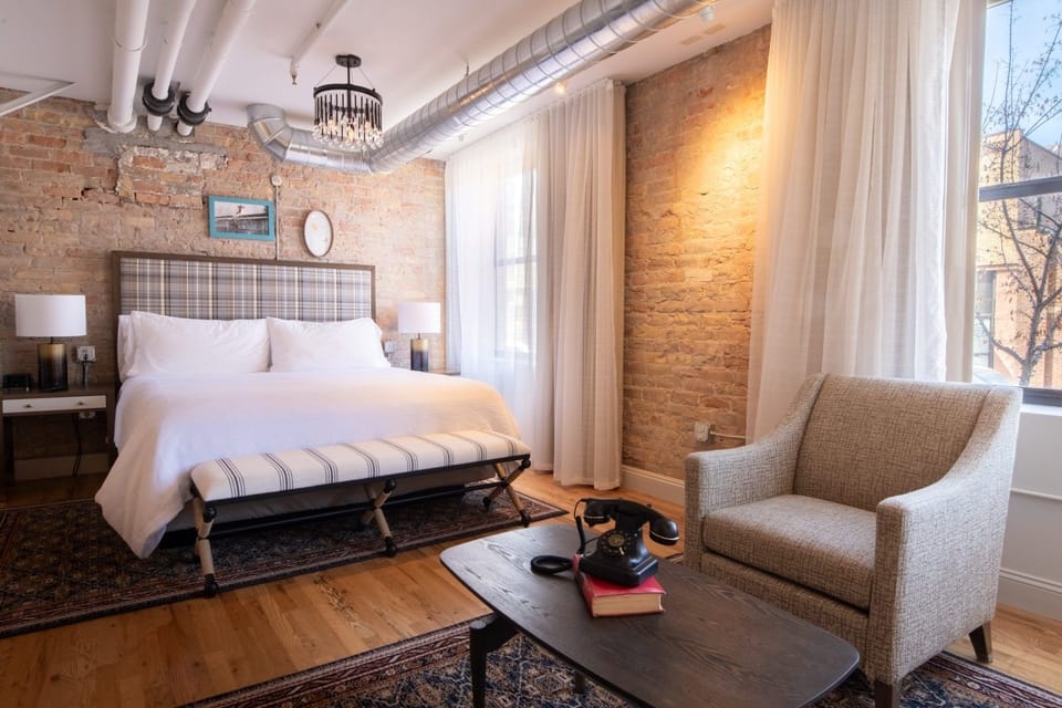 Unwind in a sunlit loft bedroom with exposed brick charm.