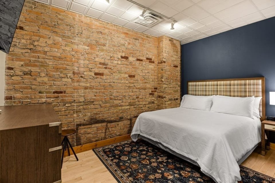 Drift off peacefully against exposed brick and soft textures.