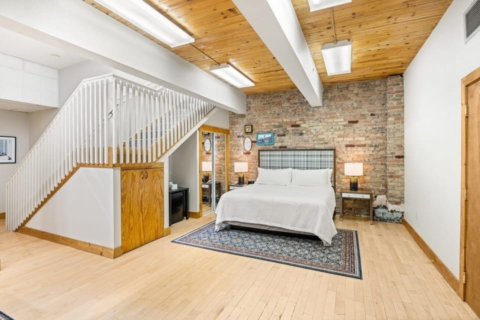 Stretch out in a loft-like room with warm wood ceilings.