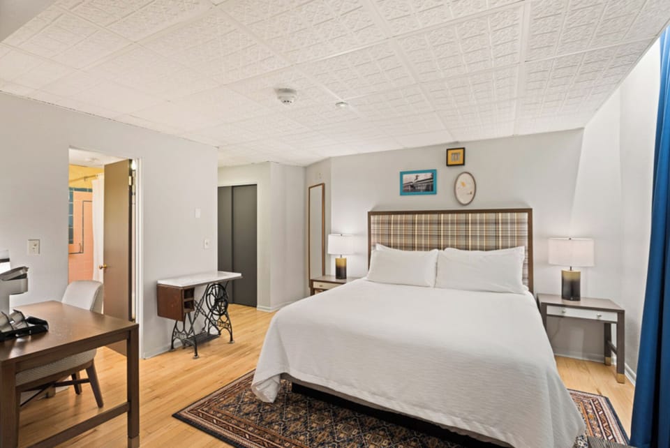 Settle in after adventures with bedside lighting and workspace.