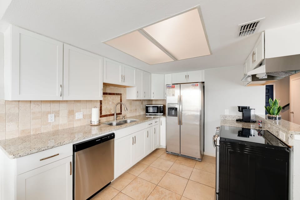 Your spacious kitchen features granite countertops, stainless steel appliances, and everything needed to prepare memorable meals during your stay.