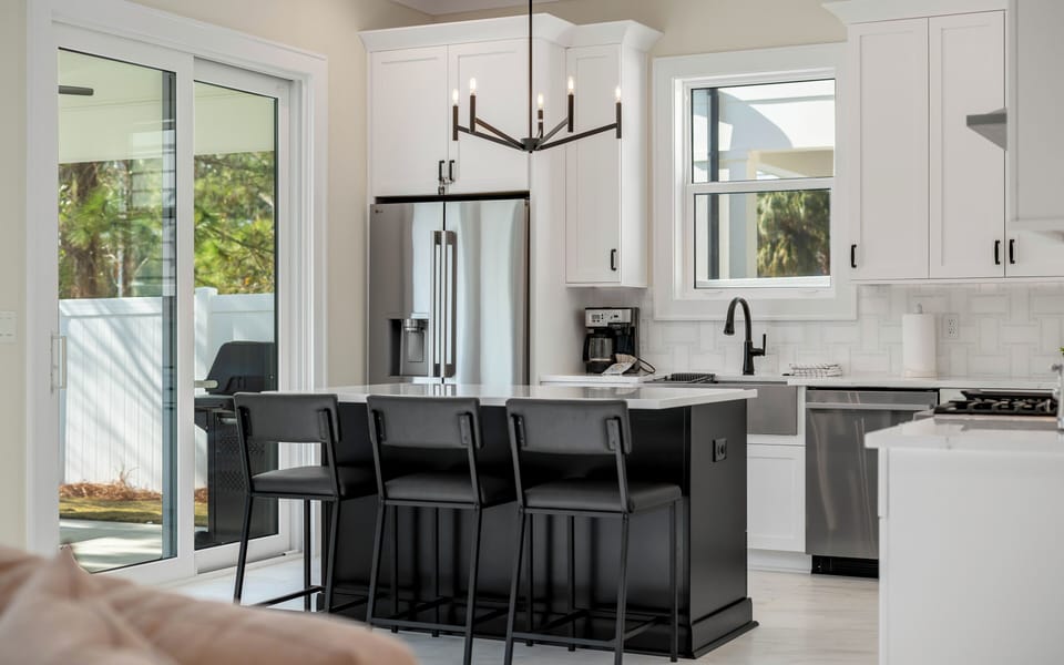 Cook and entertain with ease in your modern kitchen featuring stainless appliances, marble counters, and a spacious island for gathering.