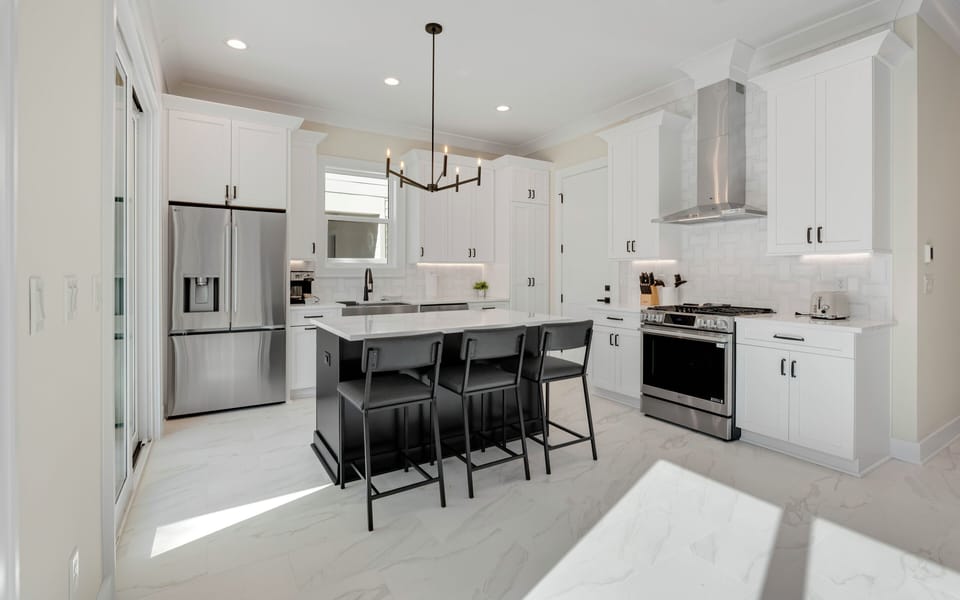 Step into your gourmet kitchen where crisp white cabinets and sleek countertops create the perfect space for culinary adventures and morning coffee moments.