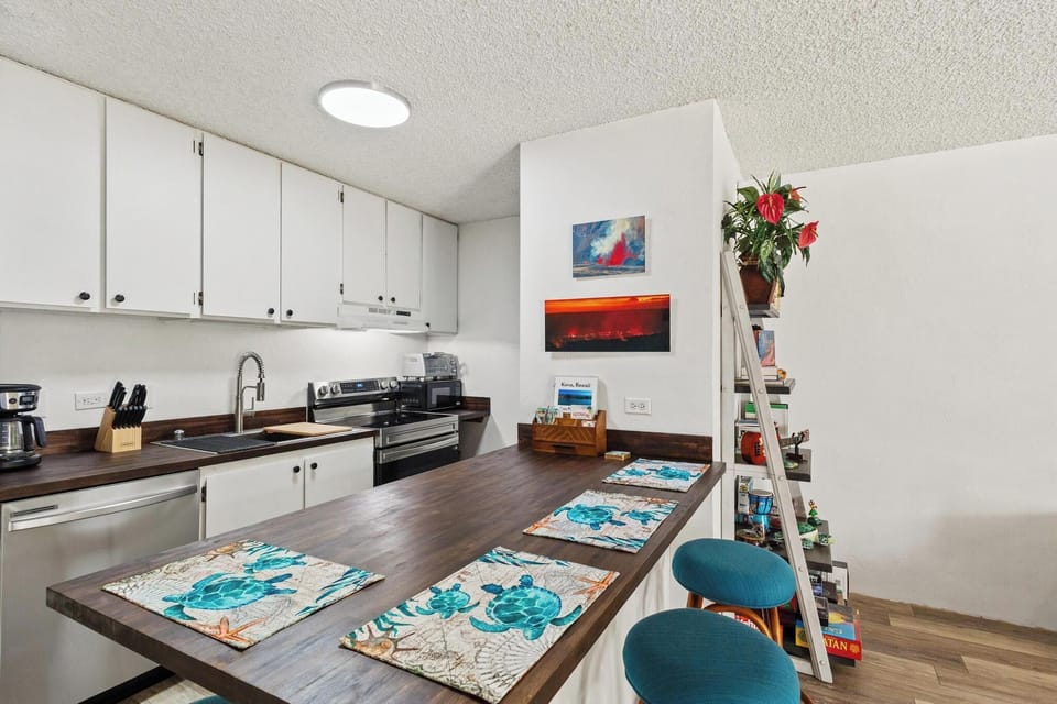 Your fully equipped kitchen features warm wood countertops, modern appliances, and a welcoming breakfast bar perfect for enjoying meals with family or planning your day's adventures.