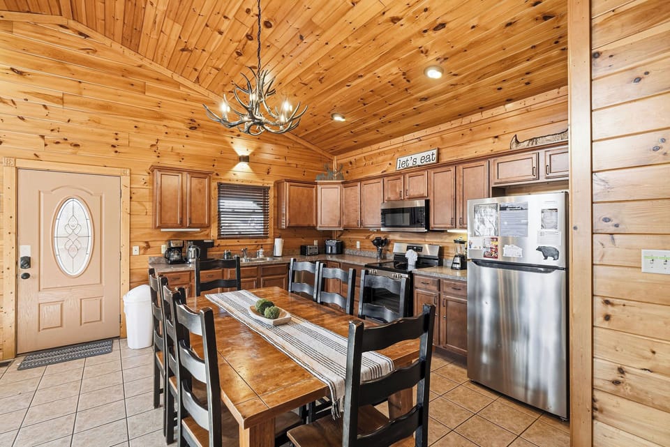 Your rustic kitchen features warm wood beams, full appliances, and a cozy dining table where you'll savor meals together.