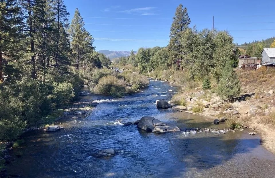 Unwind beside the sparkling river with soothing mountain views.