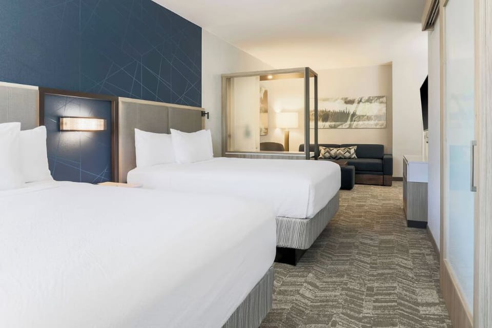 Recharge in plush beds within a bright, modern room.