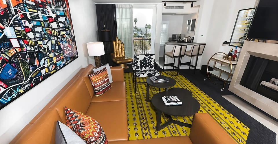 Relax on the leather sofa beside art-filled, vibrant decor.