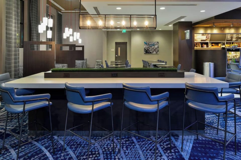 Sip and socialize at the sleek bar with plush stools