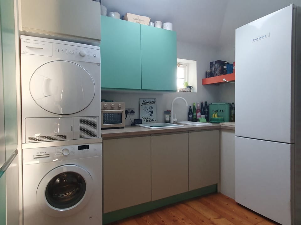 Kitchen utility room with large fridge/freezer, washing machine and dryer