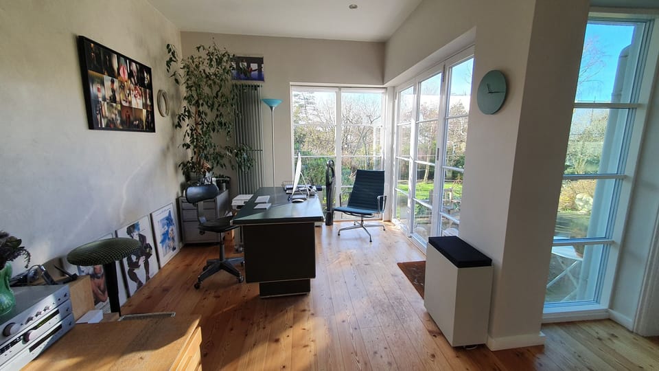 Office with bifold doors opening onto garden