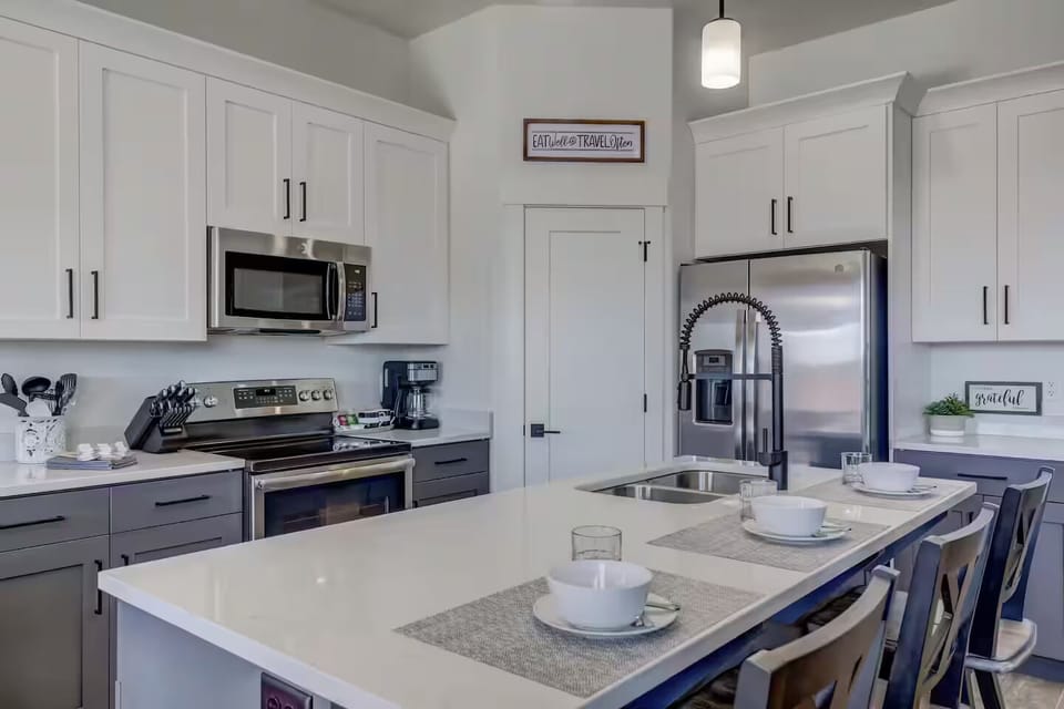 You have cooking creations at your fingertips with a fully stocked kitchen with stainless steel appliances and solid-surface countertops.