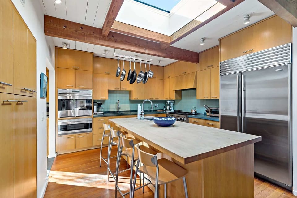 Spacious Wellfleet kitchen with island seating and stainless appliances, where you can easily entertain for family and friends