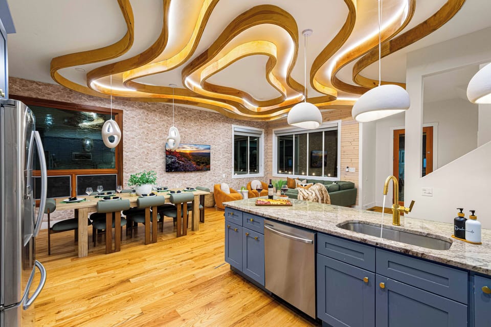 A bright, family-centered kitchen and dining area with beautifully lit ceilings!