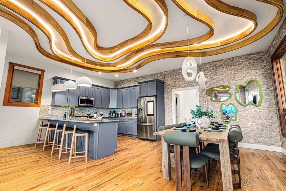 A bright, family-centered kitchen and dining area with beautifully lit ceilings!