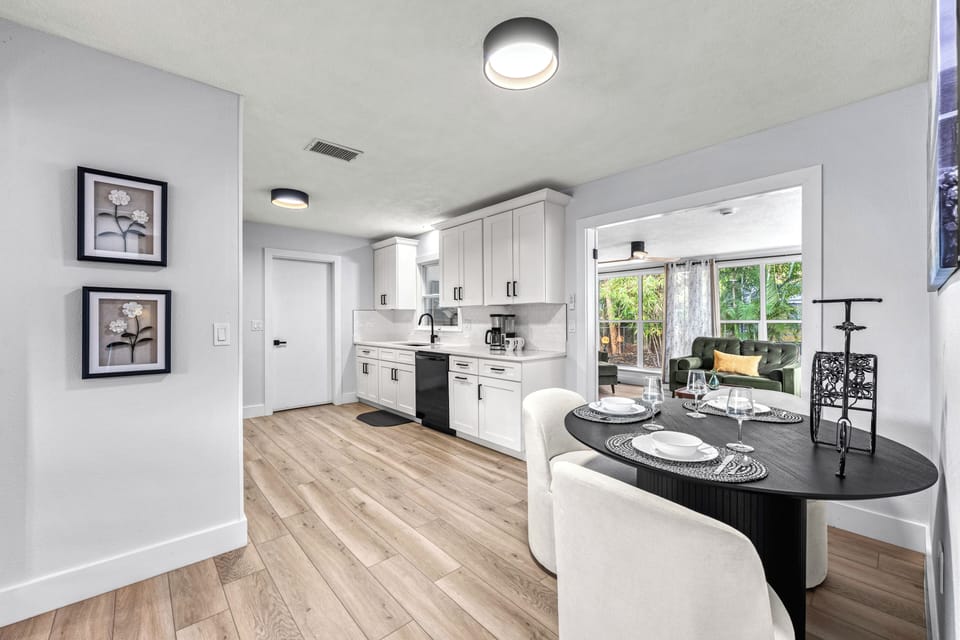 A spacious dining kitchen with soft tones and breezy cottage character.