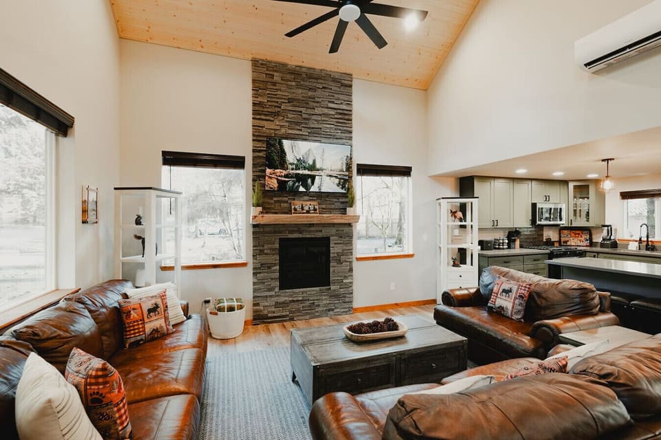 Living Room- Open Concept, Vaulted Ceilings, Ceiling fan and mini-split (Heat/AC) for year-round comfort!Perfect place to relax and unwind together - watch movies, play board games or enjoy conversation and a beverage!