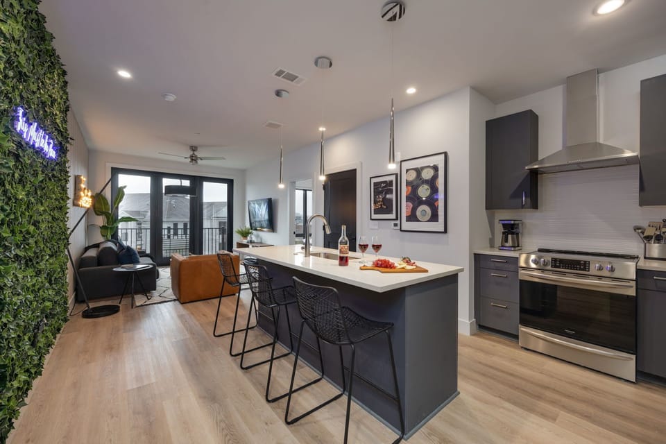 Open-concept layout showing the seamless transition from the kitchen island to the living area.