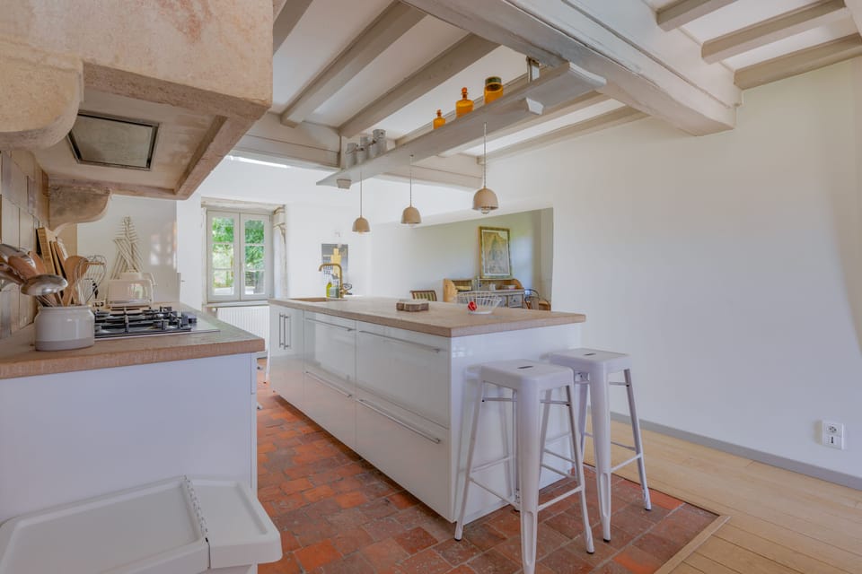 Large, fully equipped kitchen with access to the dining room and terrace.