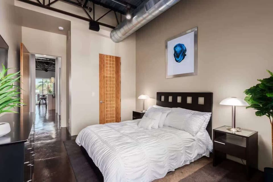 Third bedroom features a King bed, smart TV, dresser, closet, and a private patio with views of Old Town Scottsdale.