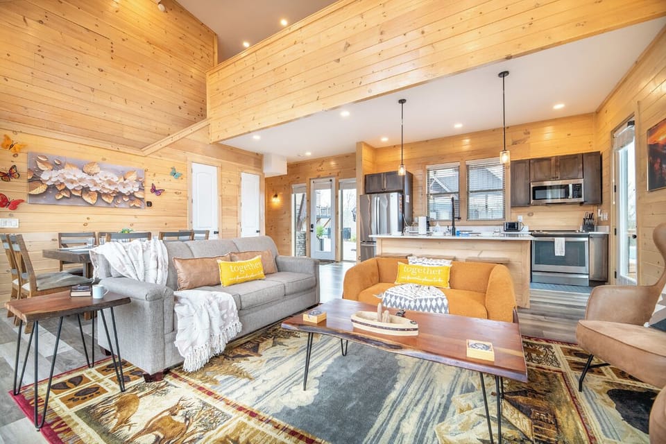 Curl up with your morning coffee in this bright open-concept cabin, where warm wood beams and cozy furnishings create the perfect mountain retreat.