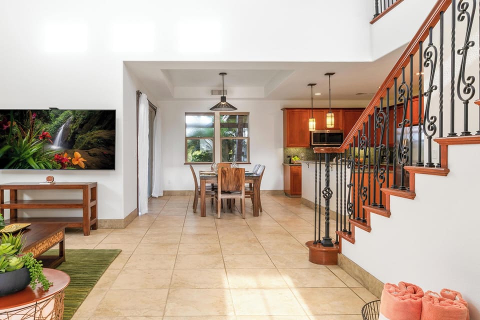 Step into your open-concept haven where rich wood accents and gleaming tiles create warmth throughout your living and dining spaces.