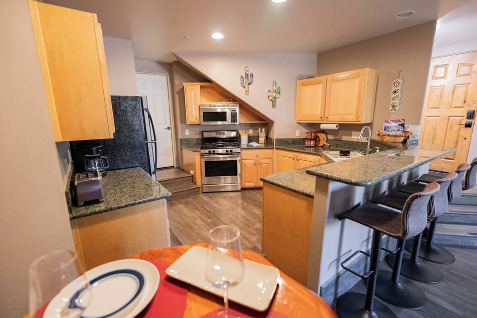 Your spacious kitchen awaits with granite countertops, stainless steel appliances, and a breakfast bar where you can sip morning coffee.