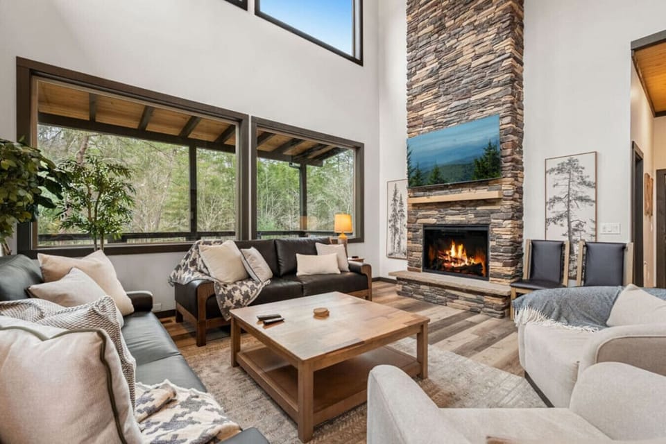 Gather around the stunning stacked-stone fireplace as the flames flicker and the Smoky Mountain views glow through the wall of windows.