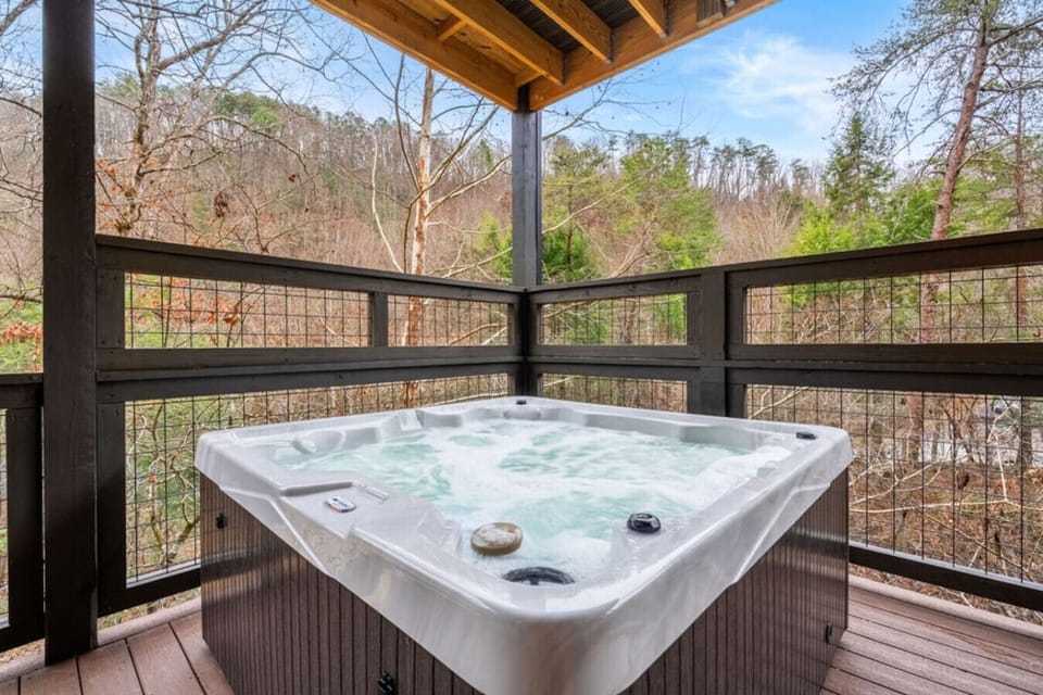 Let the bubbles melt your stress away in the private hot tub, perfectly perched for peaceful views of the surrounding woods.