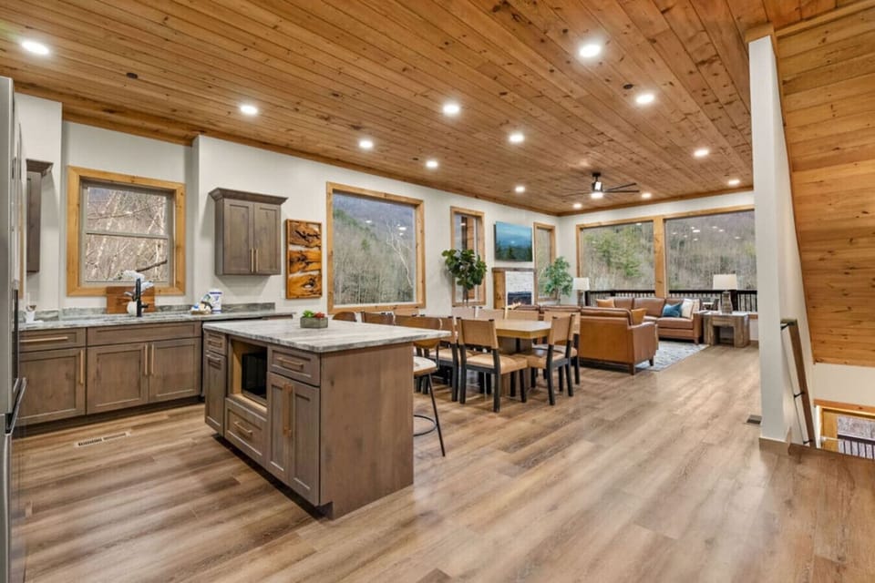 This open-concept space blends cooking, dining, and lounging into one seamless experience. Huge windows bring in the light and the views, while natural wood ceilings create that cozy cabin vibe.
