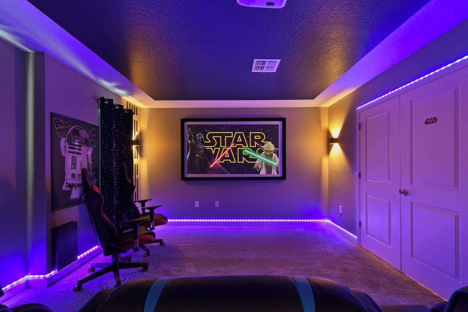 Experience a lively entertainment room with soft purple lighting, perfect for movie nights or gaming. Relax in stylish gaming chairs as you enjoy your favorite films or immerse yourself in thrilling games on the large screen.