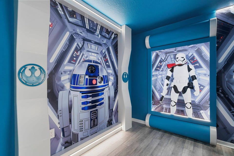 Immerse yourself in a vibrant, themed room that takes you to a galaxy far away, with stunning murals of iconic characters on a bold blue backdrop. The sleek, modern design is ideal for relaxation and playful adventures.