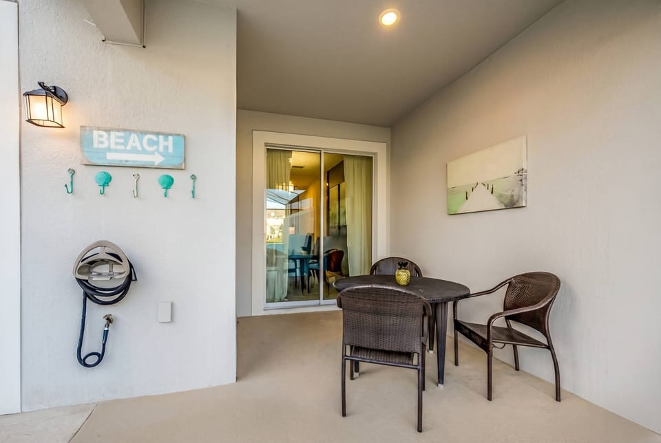Step onto your private patio, where cozy wicker chairs invite you to unwind. The subtle beach-themed decor and soft lighting create a calming ambiance, perfect for sipping morning coffee or evening cocktails as you plan your day.