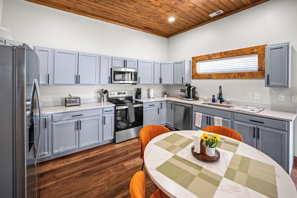 Fully equipped kitchen with Keurig coffee station, coffee, and creamer