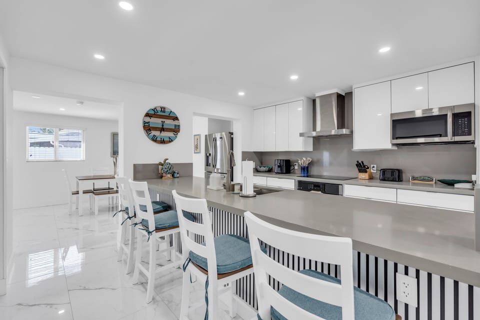 Kitchen - large countertop space, countertop chairs, and basic cooking tools.
