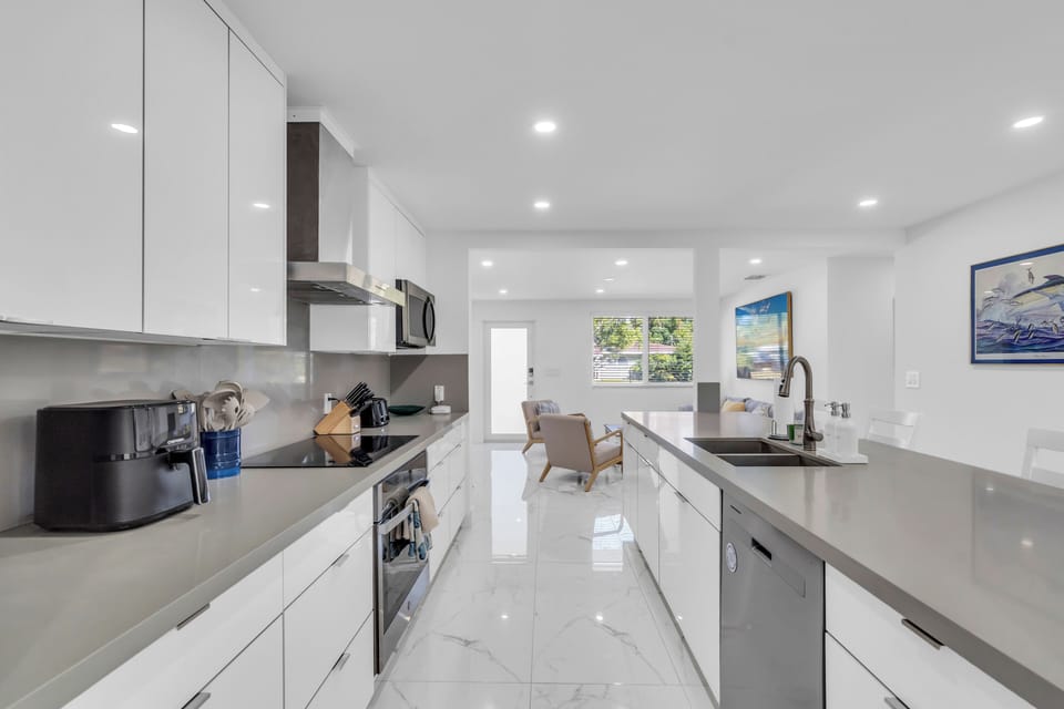 Kitchen - large countertop space, countertop chairs, and basic cooking tools.